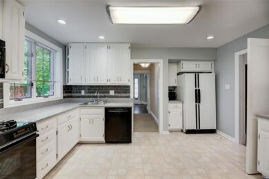 The cheerful kitchen includes raised panel white c