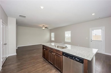 Kitchen with stainless steel dishwasher, a sink, a