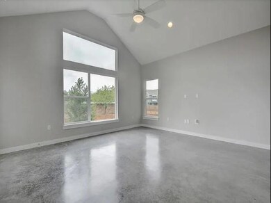 Spare room with finished concrete flooring, a cei