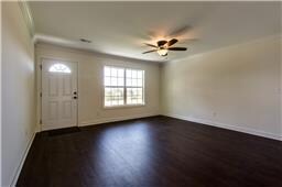 View of front door and living room. Not actual home but picture of similar home.