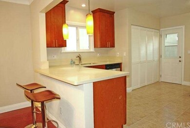 Breakfast bar with quartz countertops, laundry doo