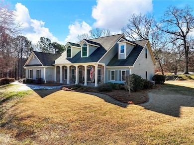 New england style home featuring a porch and a fro