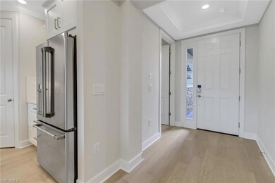Foyer featuring light wood-type flooring, baseboar