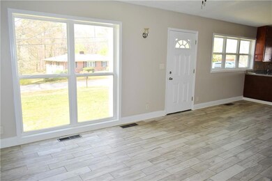 Foyer entrance with visible vents, baseboards, and