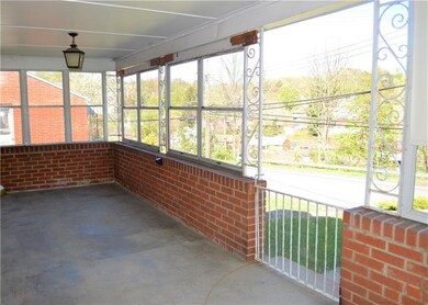 Covered front porch surrounded by windows, making 
