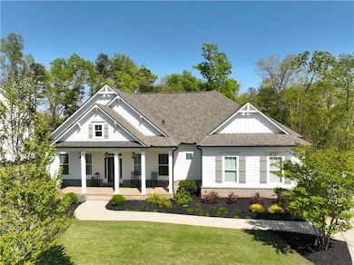 View of front of property with roof with shingles,