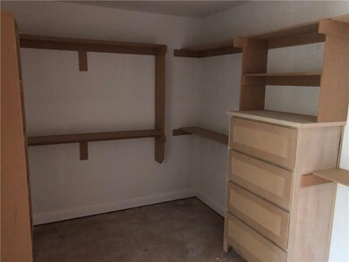 Picture shows only part of master closet. Shoe rack and built in dresser.