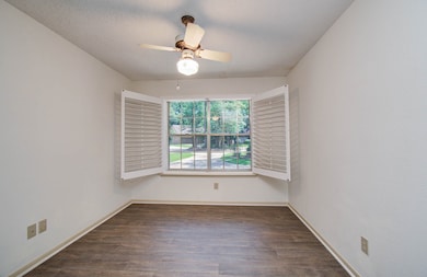 Bedroom facing the front with bay window and plant