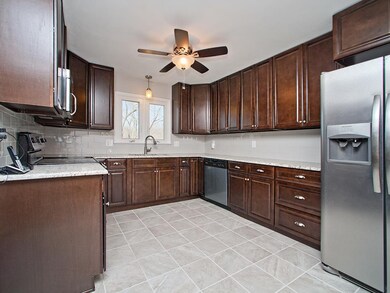 Newer Kitchen Cabinets and Appliances with Tile Fl