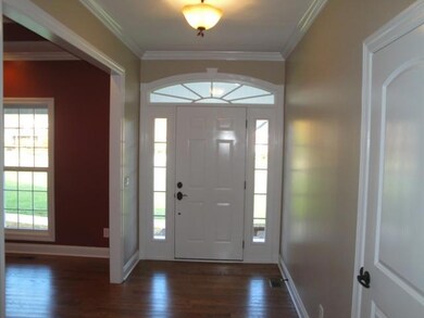 Entry Foyer is approx 12x6 w/ Hardwoods, 9' Ceilings, & Coat Closet