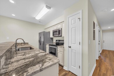 Kitchen with hardwood / wood-style floors, sink, l