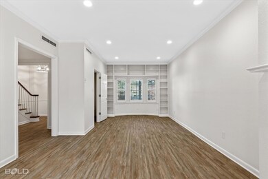 Unfurnished living room with a chandelier, hardwoo