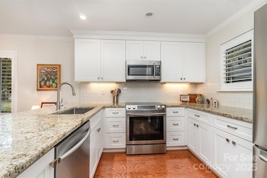 STUNNING KITCHEN WITH GRANITE , UNDERMOUNT SINK , SS APPLIANCES AND TILE BACKSPLASH 