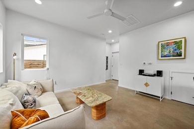 Living room with recessed lighting, finished conc