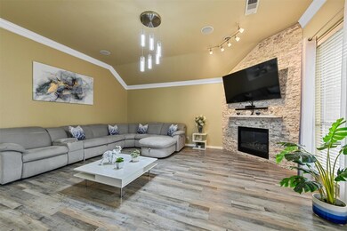 Living room with a fireplace, track lighting, ligh