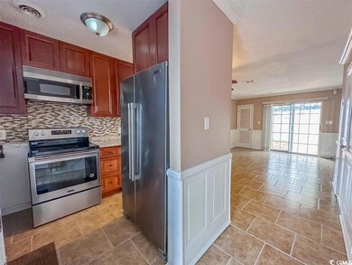Kitchen featuring backsplash, light tile patterned
