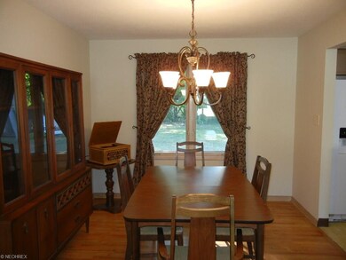 Spacious dining room with hardwood flooring and a 