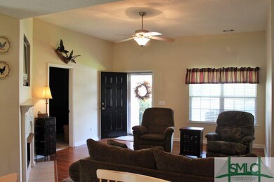 Great room with ceiling fan and fireplace