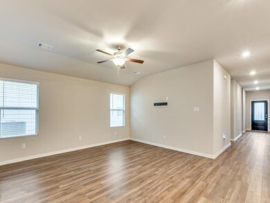 Empty room featuring ceiling fan, light hardwood /