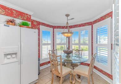 Dining room with light tile patterned floors, orna