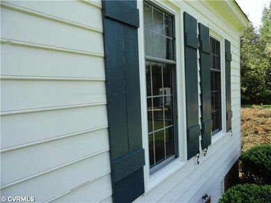 Exterior Front - Wood siding and wood shutters.