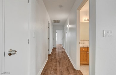 Hallway featuring light wood-style floors and baseboards