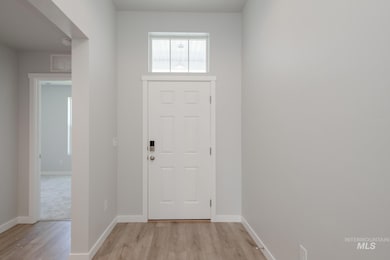 Foyer featuring baseboards and light wood-type flooring