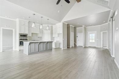 Unfurnished living room featuring a ceiling fan, light wood-style flooring, high vaulted ceiling, crown molding, and beamed ceiling