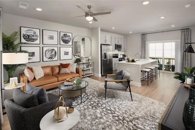 Living area with light wood-type flooring, recessed lighting, and ceiling fan