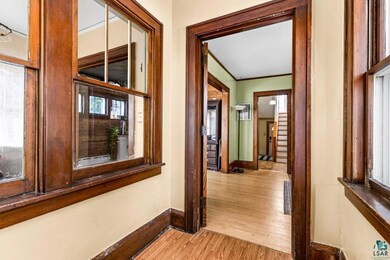 Hallway with light hardwood / wood-style flooring