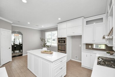 Island kitchen features quart countertops, stainle