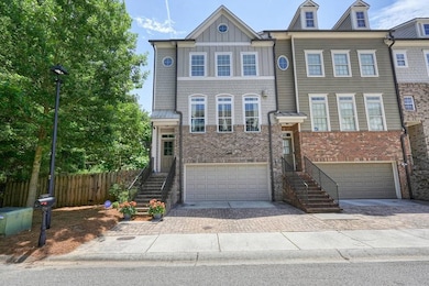View of front of house with a garage, brick siding