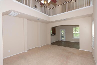 Empty room with carpet floors, arched walkways, a