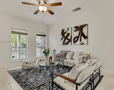 Soft natural light shines through the front windows. It’s the kind of room that feels effortlessly balanced between cozy and refined.