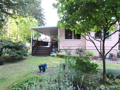 FANTASTIC SETTING!!!, FRONT DECK WITH SWEEPING VIEW OF SILVER LAKE PARK (SULLIVAN PARK), AND LAKES SHORE JUST BEYOUND THE TREES.