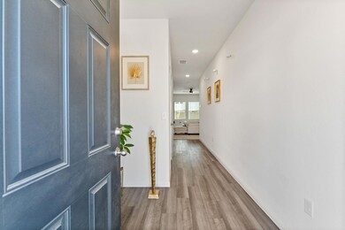 Corridor with wood finished floors and recessed lighting