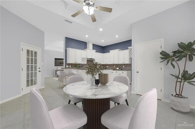 Dining space featuring light tile patterned flooring, ceiling fan, and recessed lighting