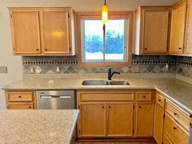 Window over sink overlooking fenced backyard.