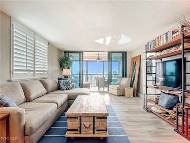 Living area featuring expansive windows, wood finish floors, and a ceiling fan