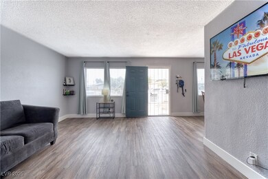 Living room with a textured wall, wood finished fl