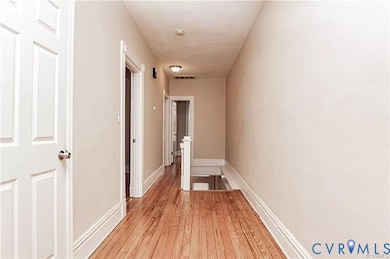 Hall featuring light wood finished floors