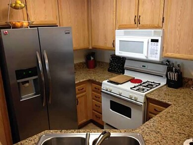 Kitchen with stainless refrigerator and dishwasher