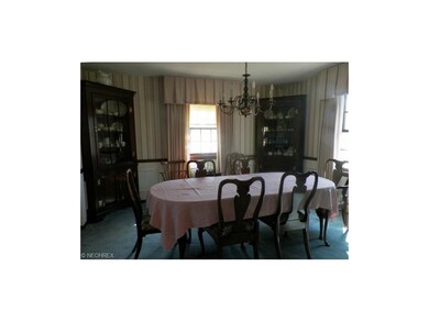 Carpeted dining room area with two full windows.