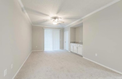 Unfurnished living room featuring ceiling fan, cro