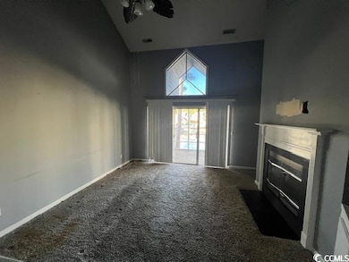 Unfurnished living room featuring carpet floors, c