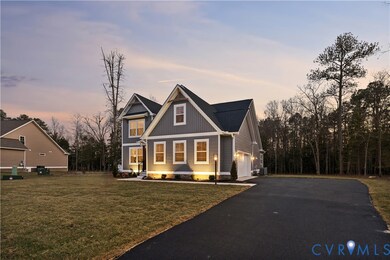 View of front of house with driveway, board and batten siding, a front lawn, and an attached garage