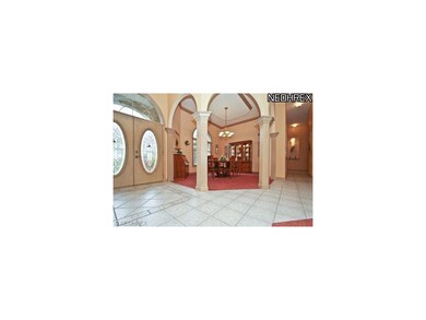 Elegant formal dining room flanked by arched flute