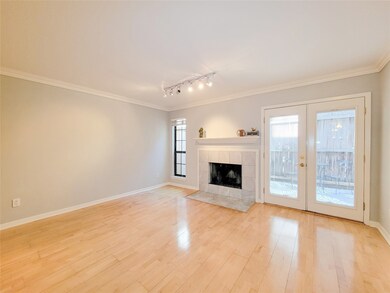 The living room features engineered wood flooring,