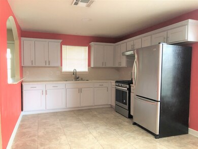 Kitchen with refrigerator and gas stove