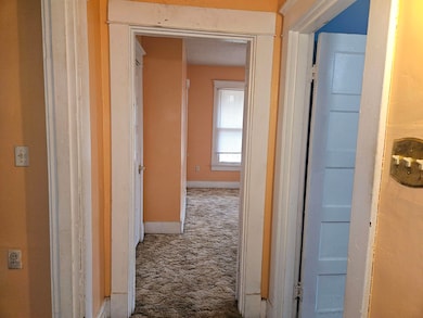 Corridor featuring carpet